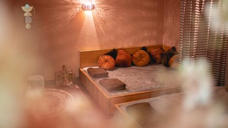 Relaxation room with lounger, cushions and oriental-style lamp